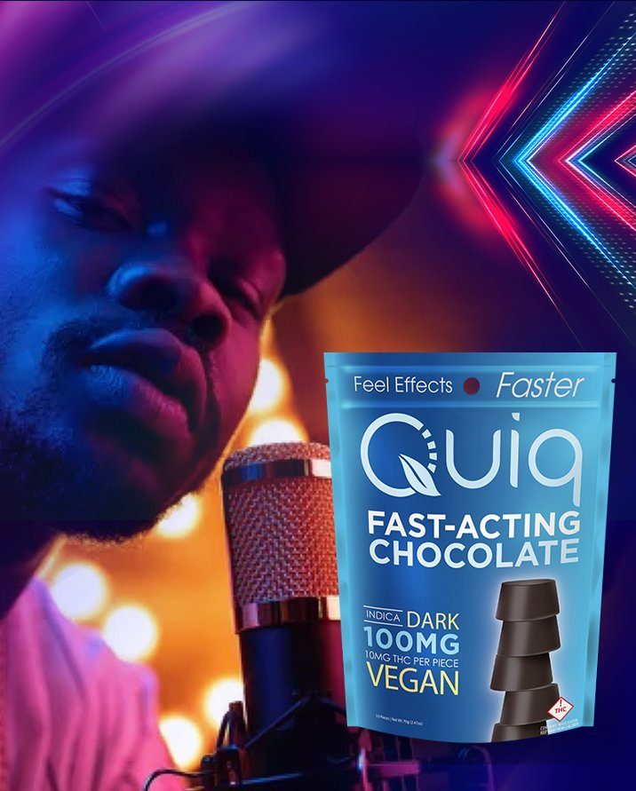 A man at a studio microphone next to a bag of Quiq Fast-Acting Chocolate, 100mg indica dark